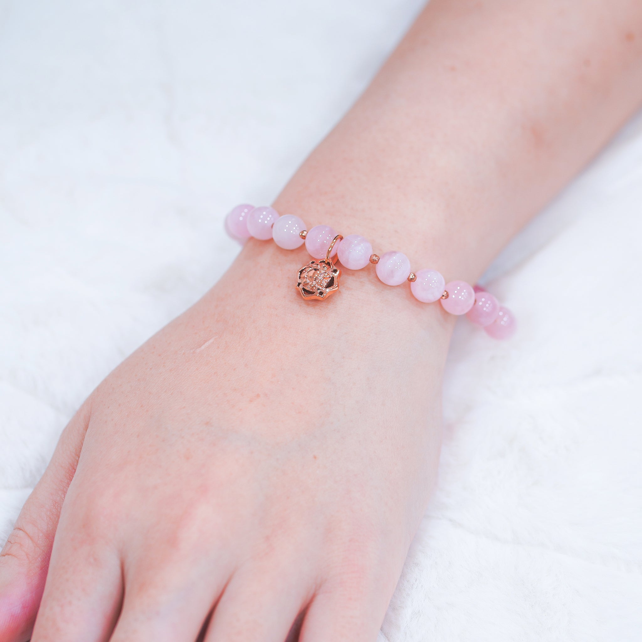 Garden of Desire - Embrace Rose Quartz Bracelet This easy-fit elastic stretch bracelet features our handcrafted 92.5 sterling silver emblem charm plated in rose gold, together with Rose Quartz and Hematite (plated in rose gold)