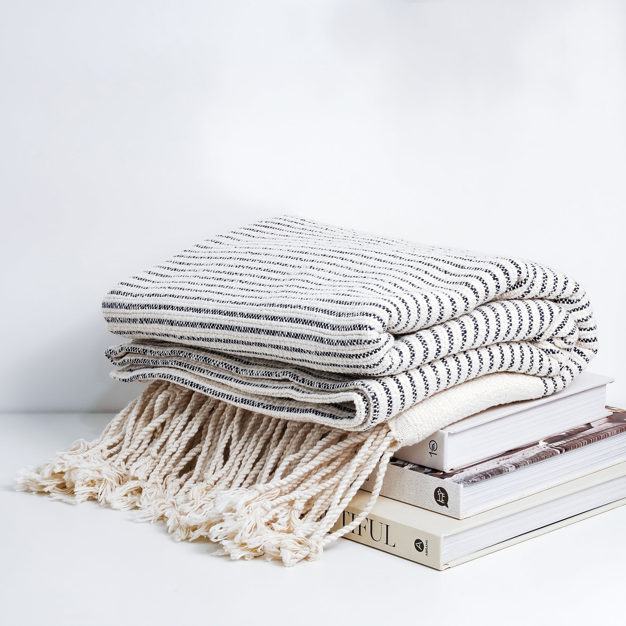 Bring comfort and style to your home with this modern and minimalist throw blanket.   This throw is large, but lightweight and perfect to cozy up with or drape over any sofa back, armchair, or foot of the bed all year long. 