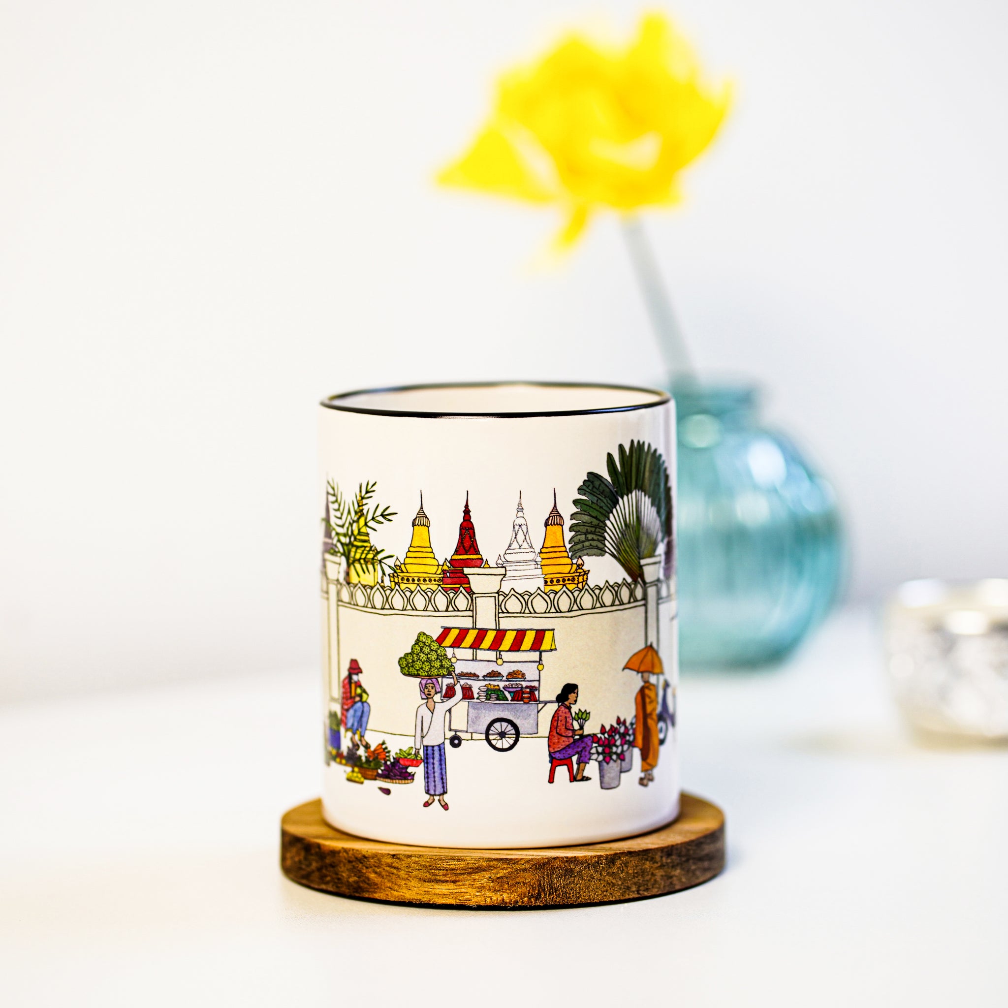 Eye-catching illustrated mug that handles your cold or hot beverage in style. This mug features an illustration that depicts everyday life in Cambodia's capital, Phnom Penh. Its rainbow-colored theme is to bring joy into your day. A perfect gift to oneself or loved ones.