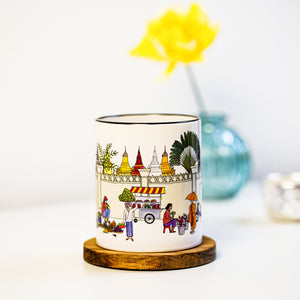 Eye-catching illustrated mug that handles your cold or hot beverage in style. This mug features an illustration that depicts everyday life in Cambodia's capital, Phnom Penh. Its rainbow-colored theme is to bring joy into your day. A perfect gift to oneself or loved ones.