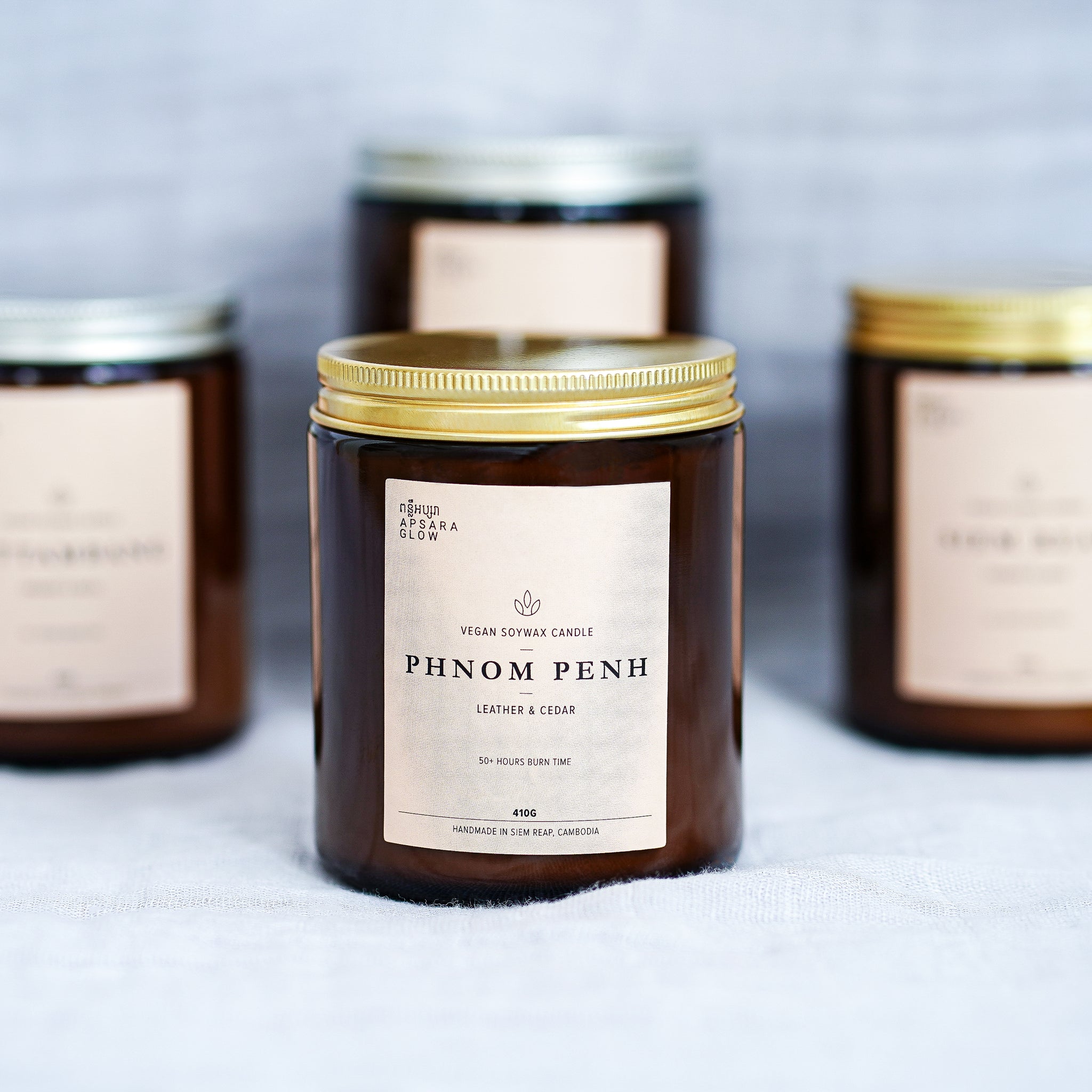Fill your room with this woody candle. This natural, vegan soy wax candle features masculine scent of smoky leather with hints of fresh woody cedar. It is inspired by the capital of Cambodia, Phnom Penh, famously known for its bustling and robust movements.